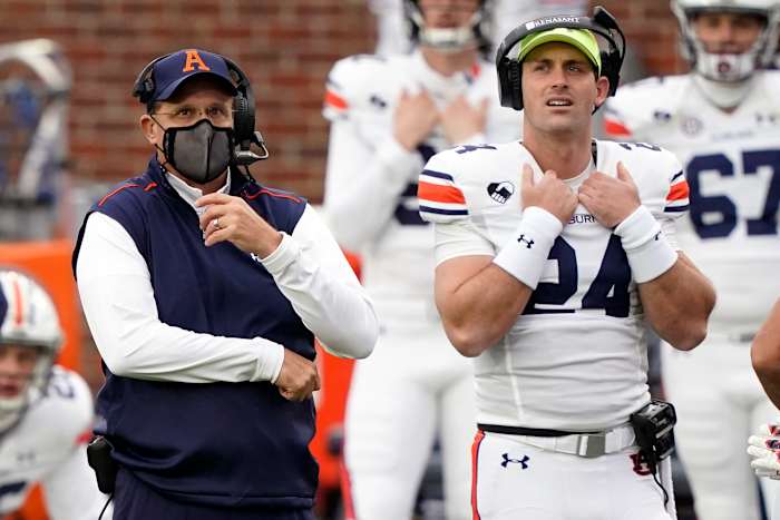 Auburn head coach Gus Malzahn, left, and Auburn quarterback Cord Sandberg (24) look at the scoreboard during the first half of an NCAA college football game against Mississippi in Oxford, Miss., Saturday Oct. 24, 2020. (AP Photo/Rogelio V. Solis)